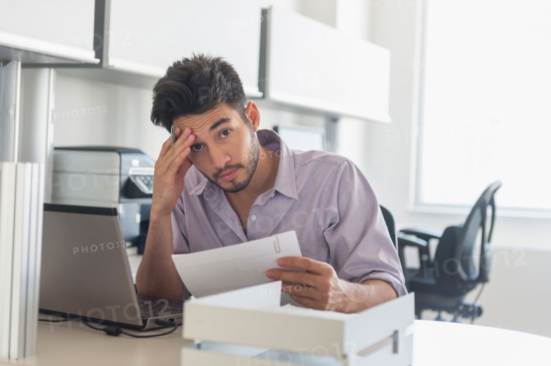 Portrait of businessman at work in office.