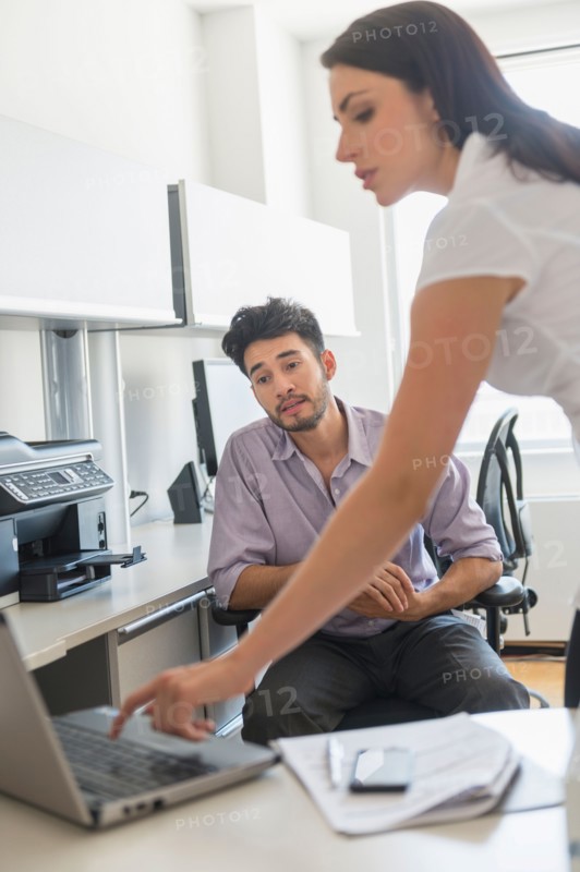 Business man and woman at work in office.