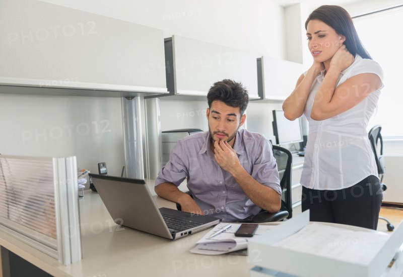 Business man and woman at work in office.