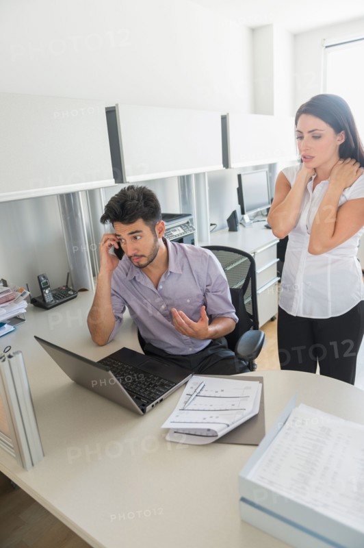 Business man and woman at work in office.
