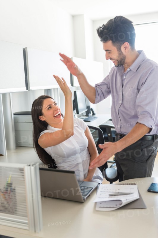 Woman and man giving high five to each other.