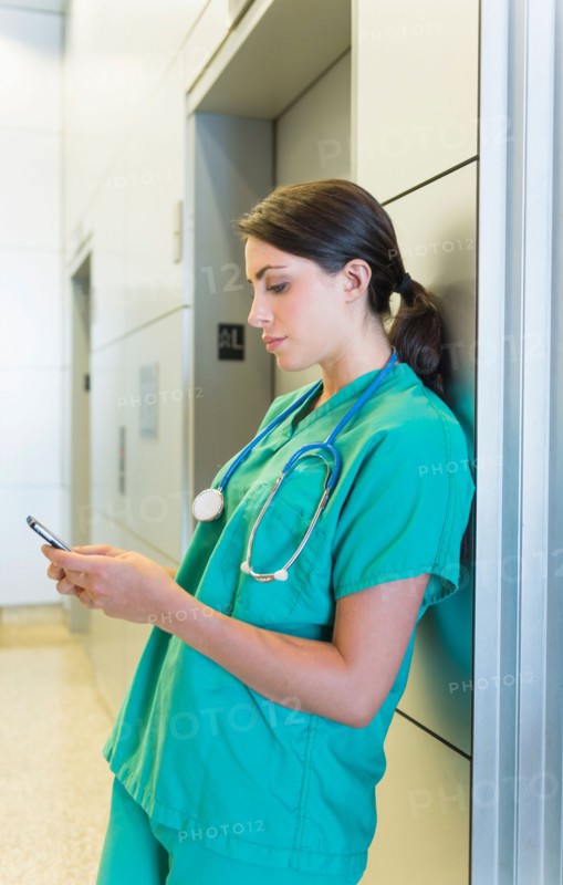 Female doctor text messaging.