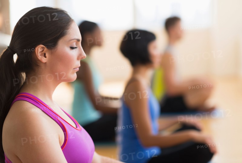 People training yoga in gym.
