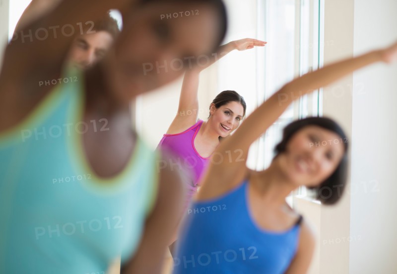 People stretching in gym.