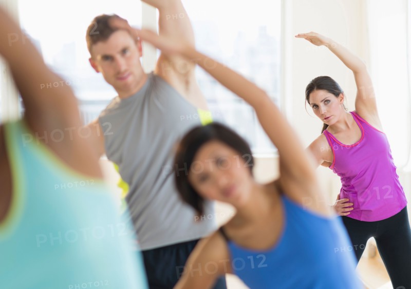 People stretching in gym.