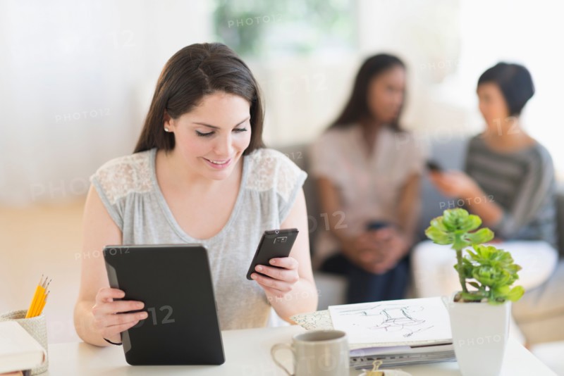 Woman using digital tablet and mobile phone.