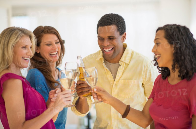 Friends making toast at party.