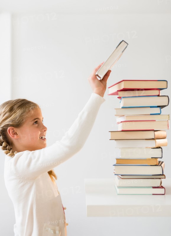 Portrait of girl (8-9) holding book