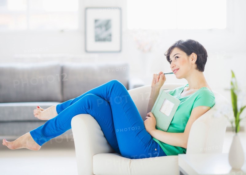 Portrait of woman holding note pad and pencil