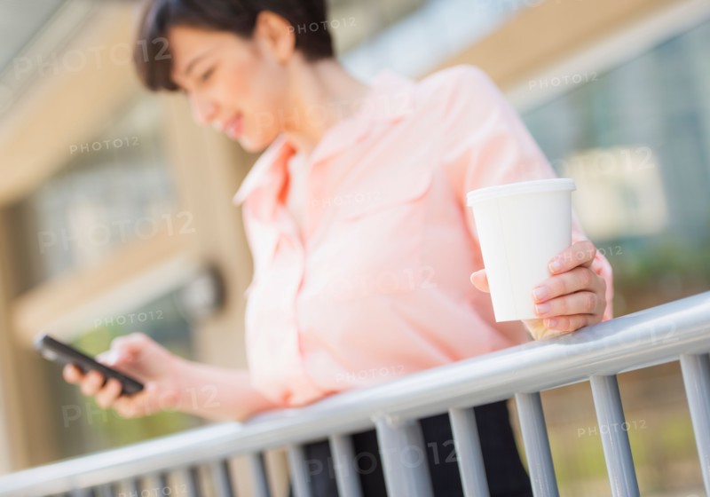 Portrait of business woman text messaging