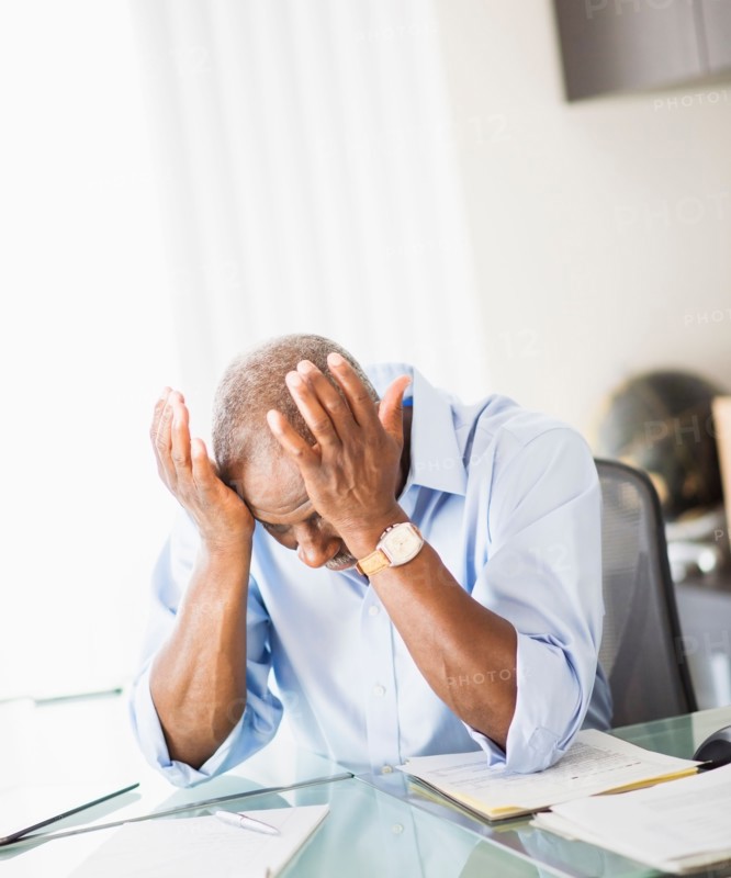 Portrait of tired senior man in office