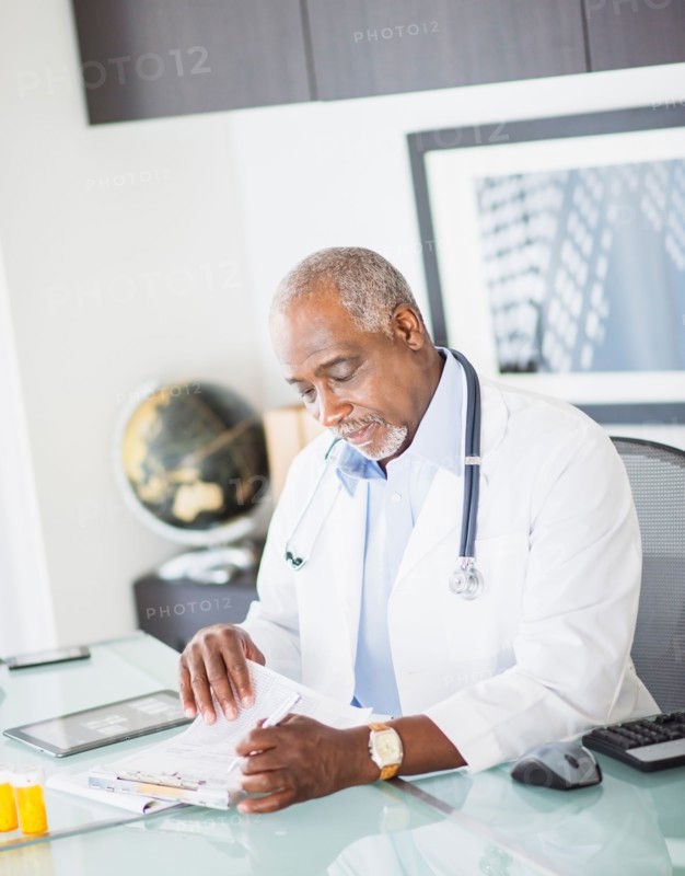 Portrait of doctor holding prescription