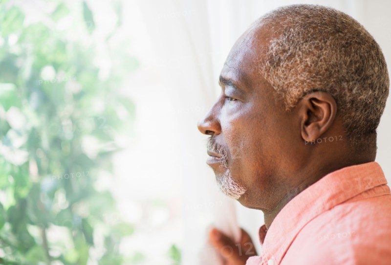 Portrait of man looking through window