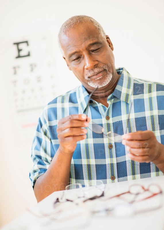 Man looking at glasses in store