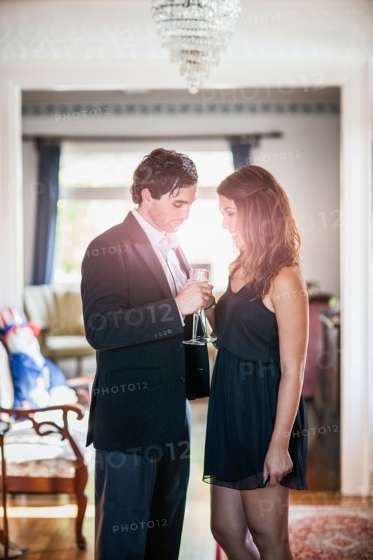 Young elegant couple drinking wine
