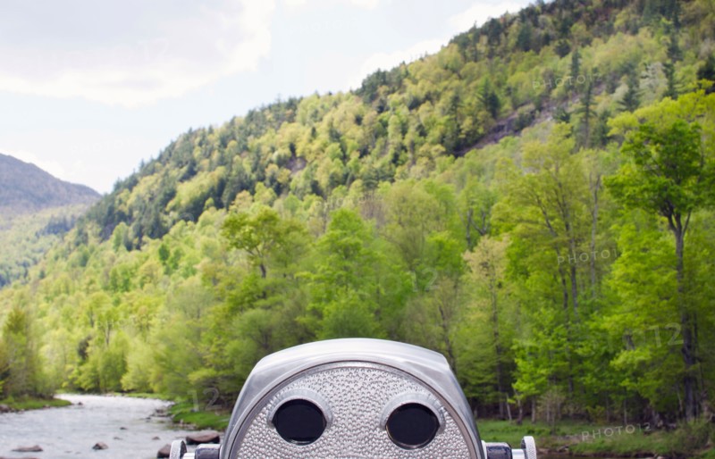 Coin operated binocular facing green hill