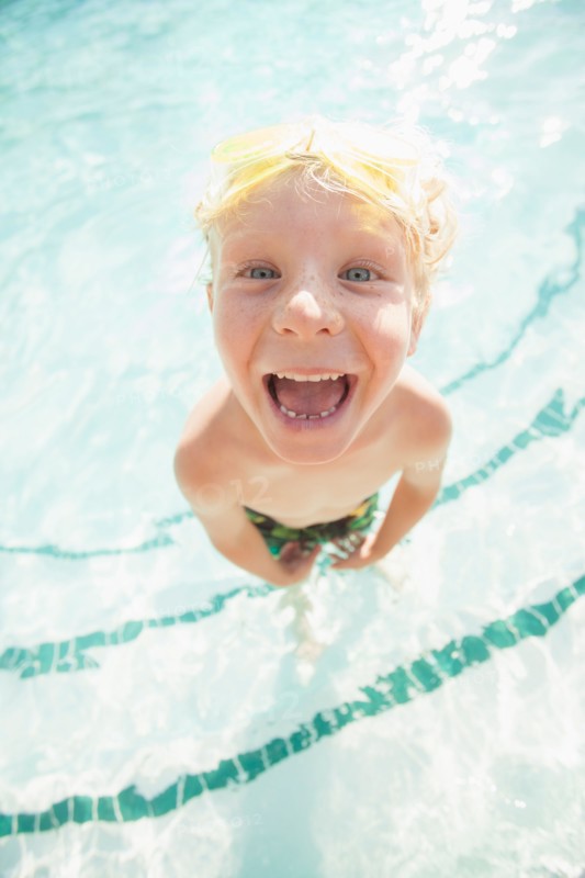 Boy (4-5) posing in swimming pool