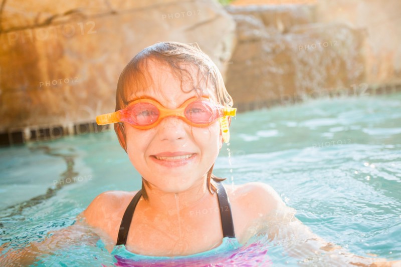 Girl (8-9) playing in swimming pool