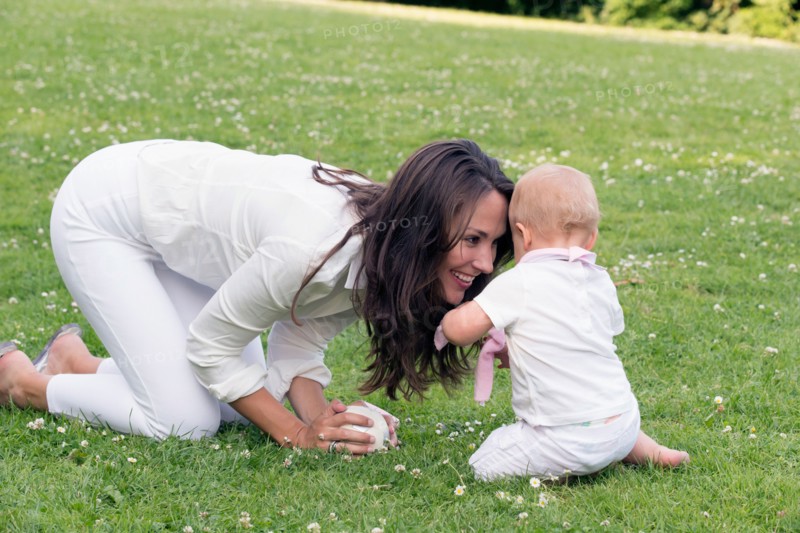 Mother and daughter (12-17 months) playing in park