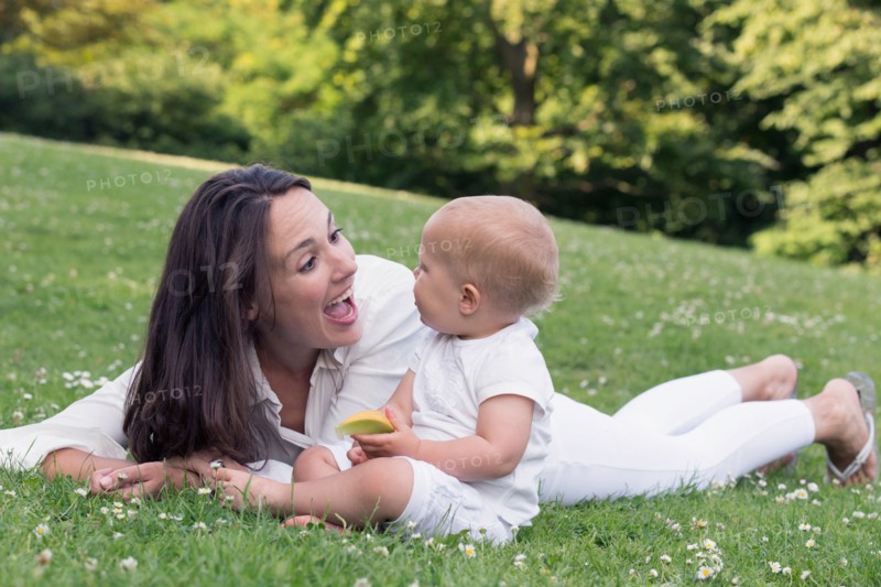 Mother and daughter (12-17 months) playing in park