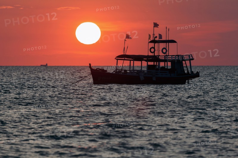 Trawler against setting sun