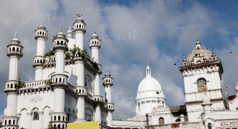 Devatagaha Mosque and town hall against cloudy sky