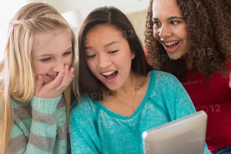 Girls (12-13,14-15,16-17) playing with tablet