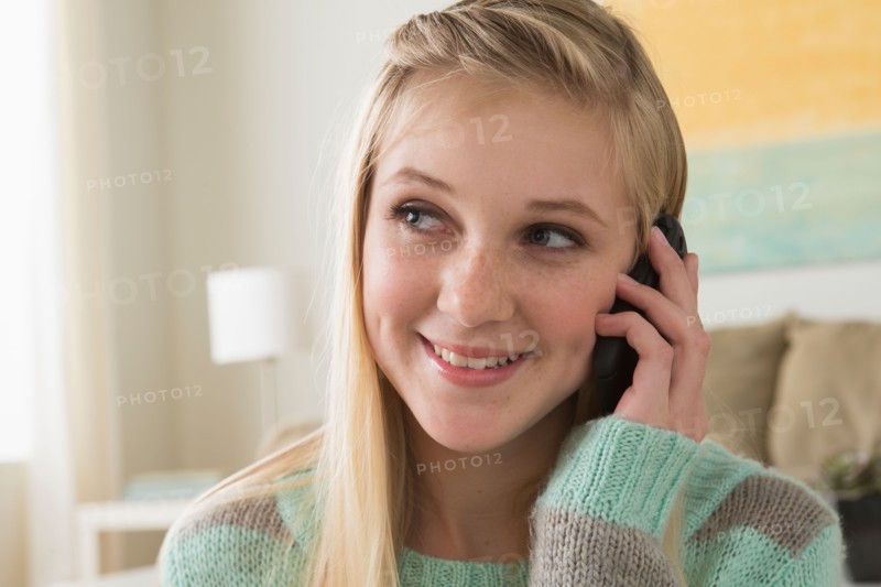 Portrait of teenage girl (14-15) with smartphone