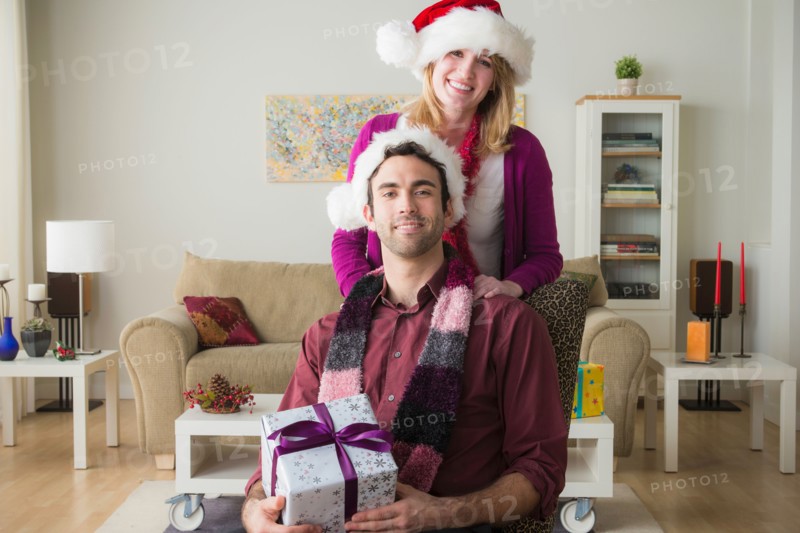 Portrait of young couple wearing santa hats
