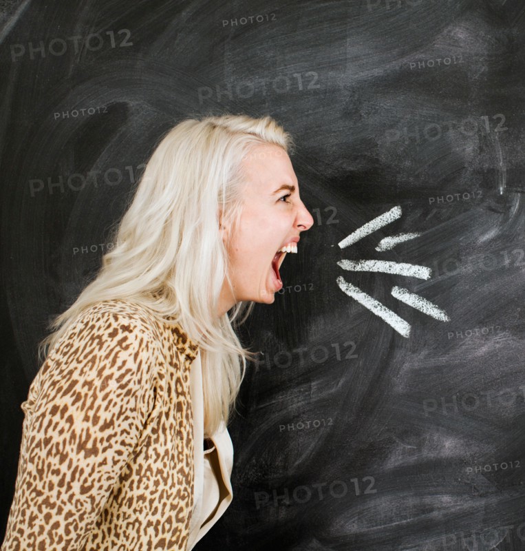 Studio portrait of young woman shouting
