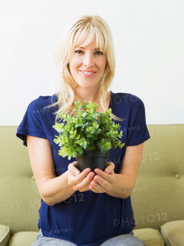 Woman holding potted plant