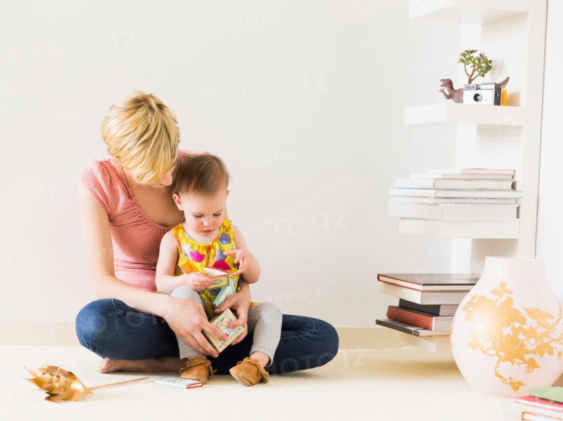 Mother playing with baby daughter (12-17 months)