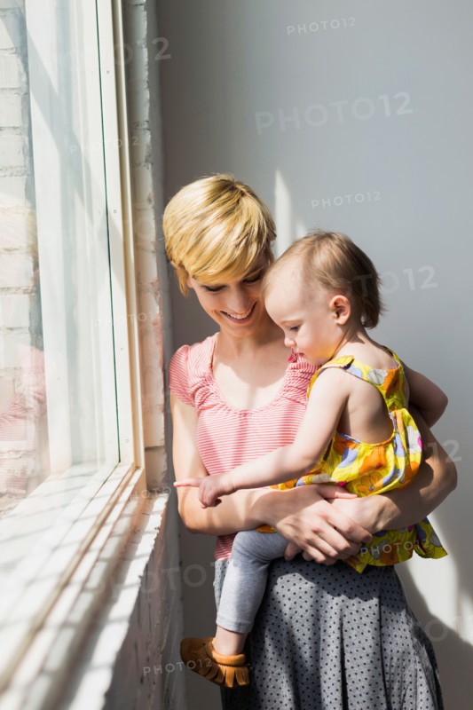 Mother holding daughter (12-17 months)