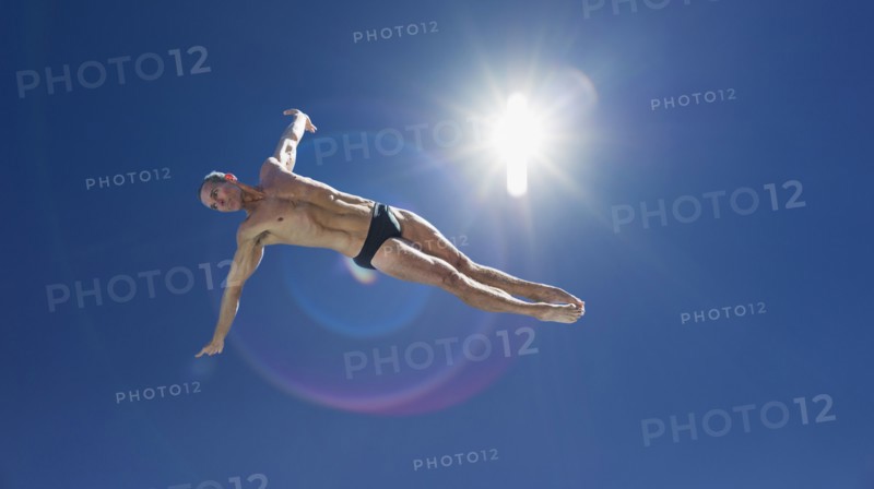 Athletic swimmer jumping.