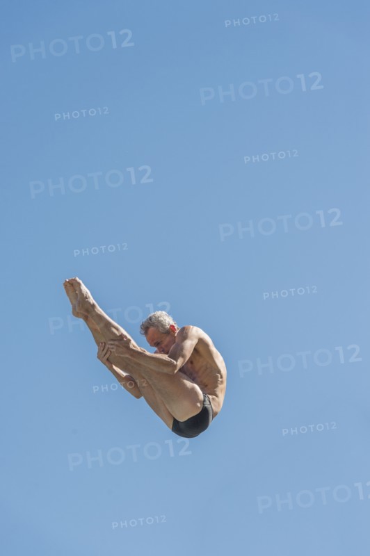Athletic swimmer jumping.