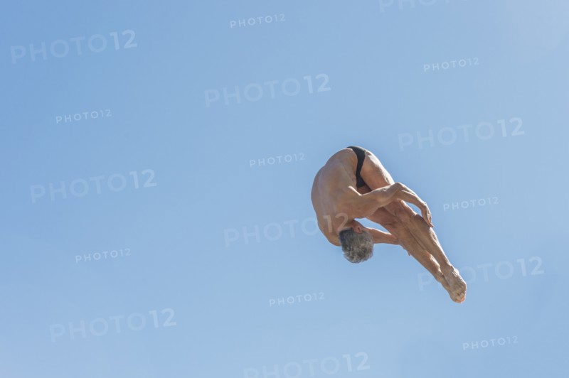 Athletic swimmer jumping.