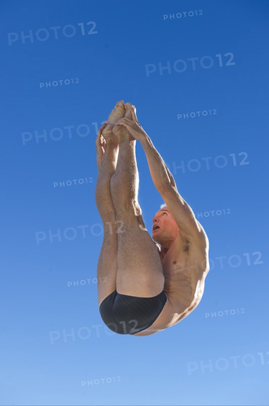 Athletic swimmer jumping.