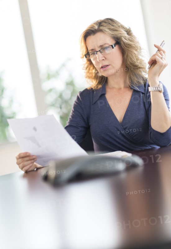 Business woman reading document.