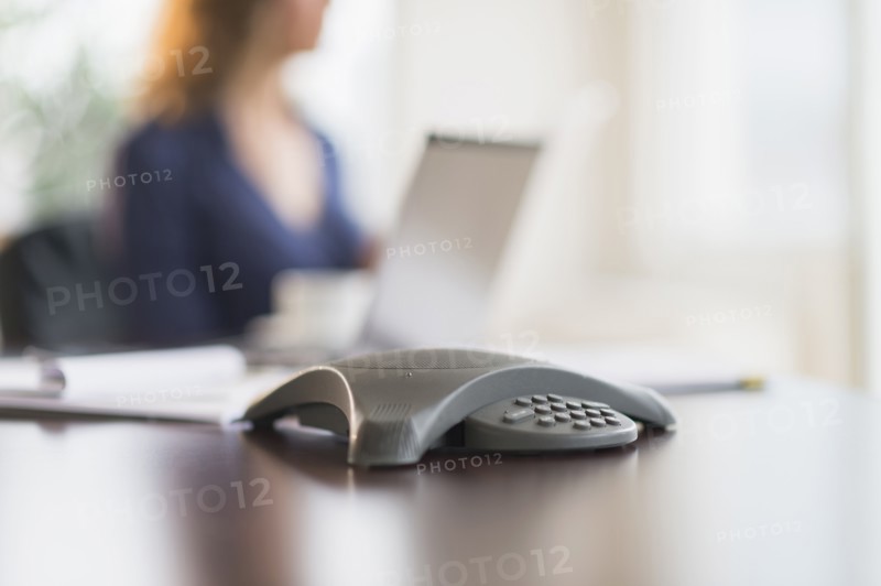 Business phone on office desk.