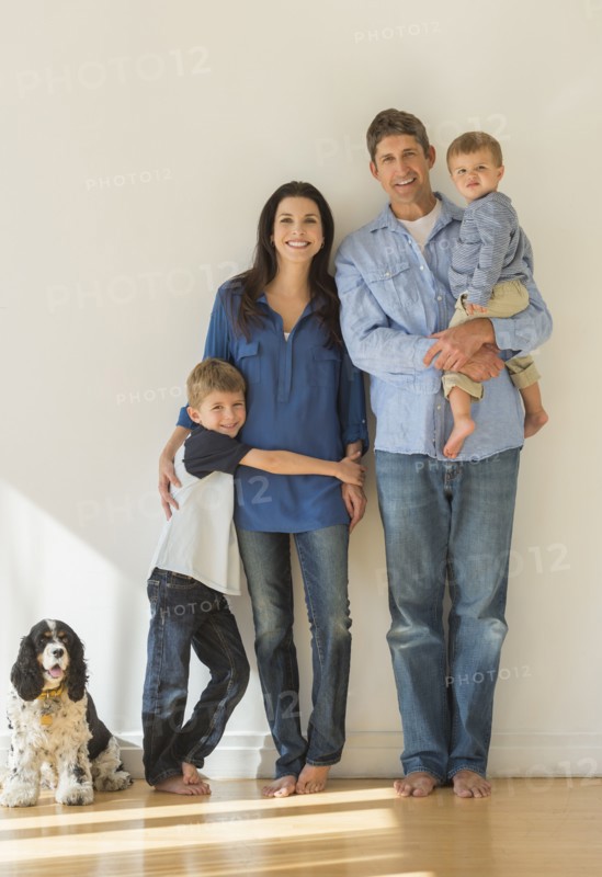 Portrait of parents with two sons (12-17 months, 6-7) and dog.