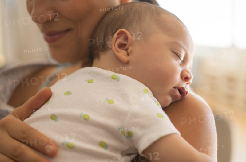 Mother holding baby (2-5 months).