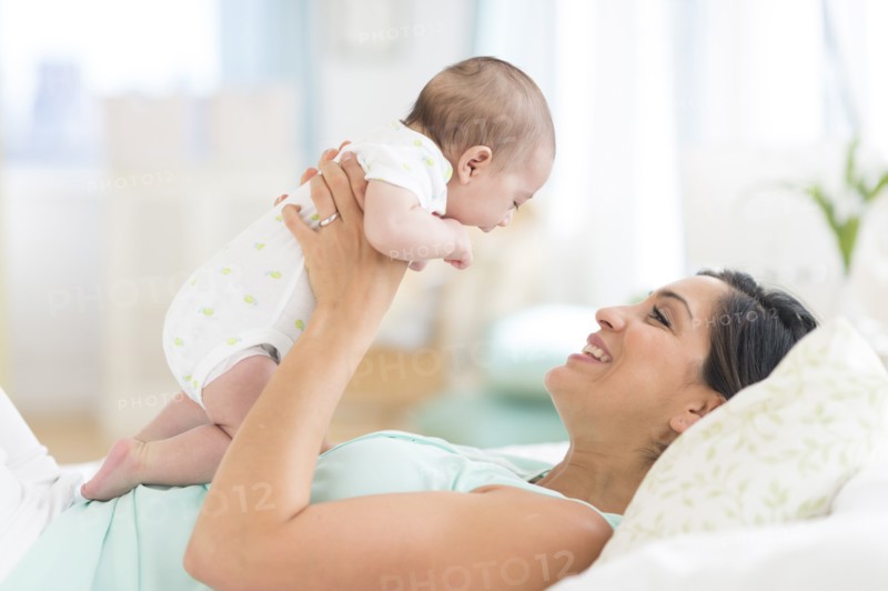 Mother playing with baby (2-5 months).