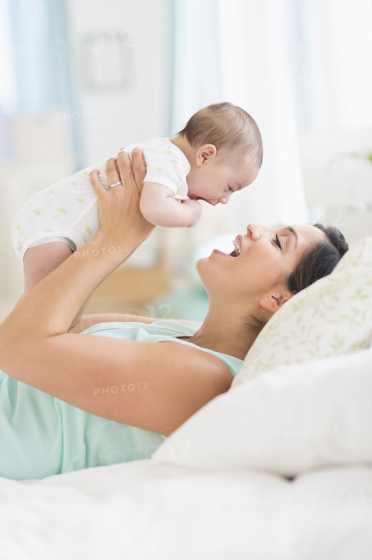 Mother playing with baby (2-5 months).