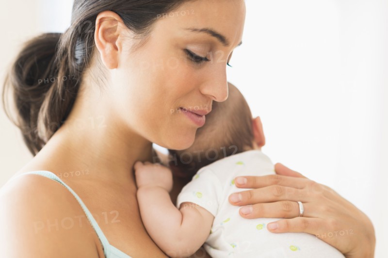 Mother holding baby boy (2-5 months).