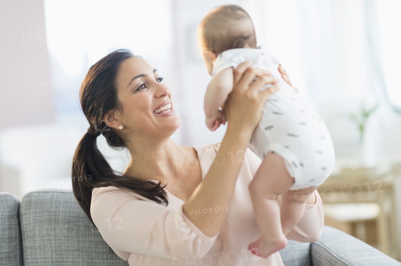 Mother holding baby boy (2-5 months).