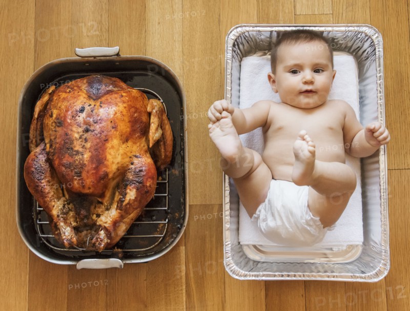 Baked turkey and baby girl (2-5 months) in baking dish.