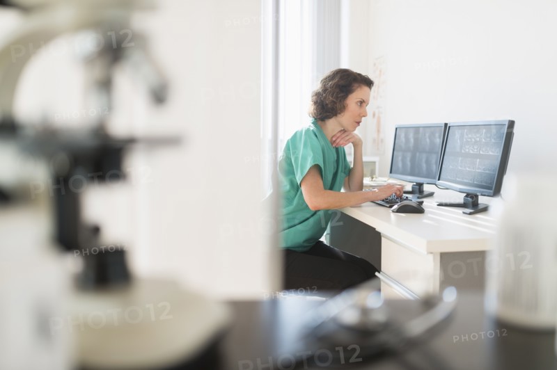 Female technician working on computer.