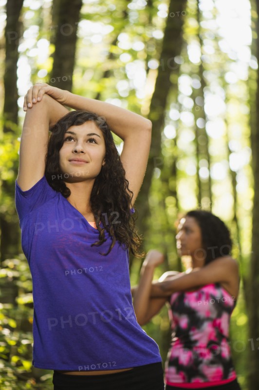 Two young women stretching. USA, Oregon, Portland.