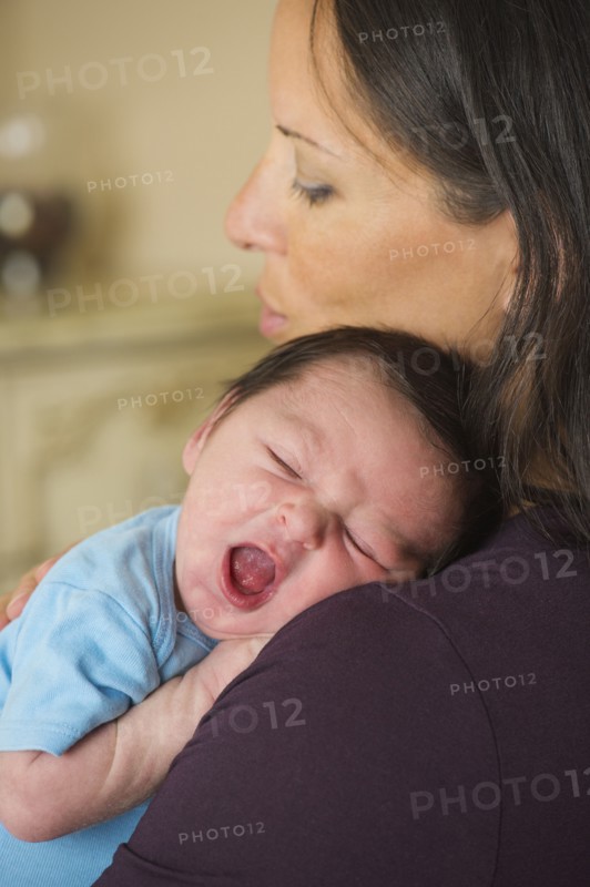 Portrait of mother holding newborn baby (0-11 months).