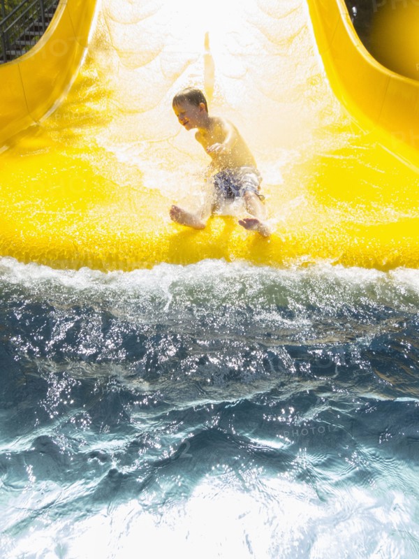 Boy (6-7) having fun on water slide. Germany, Thuringia.
Photo : JOHANNES KROEMER